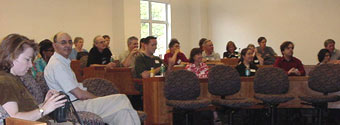 Attendees listen attentively to the speakers.